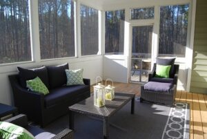 room with purple couches and green pillows