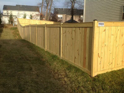 cedar fence along left side of house and front corner